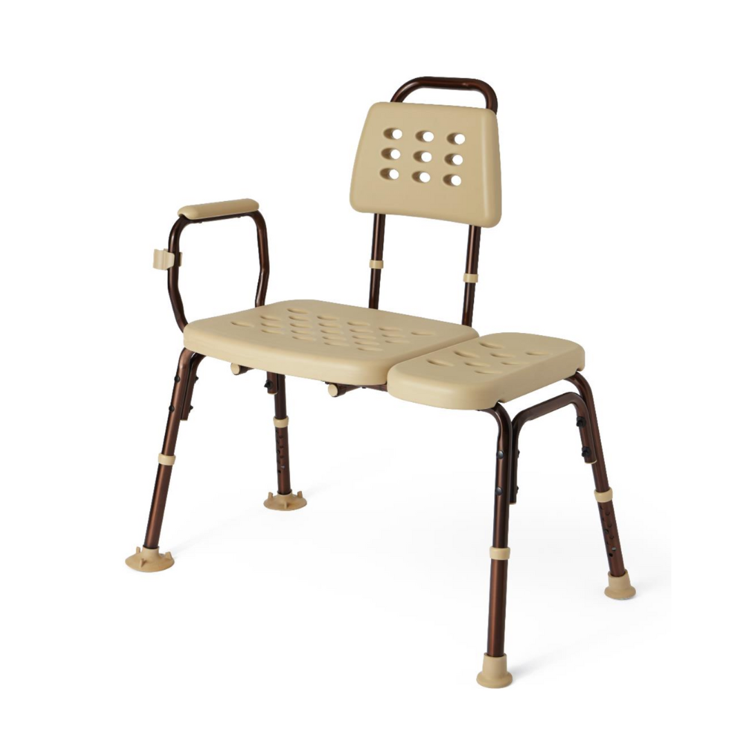 The Medline Transfer Bench with Microban is beige and height-adjustable, featuring a backrest and armrests on a brown frame. The perforated seat aids drainage and has a removable section, while nonslip rubber tips on the legs enhance stability.